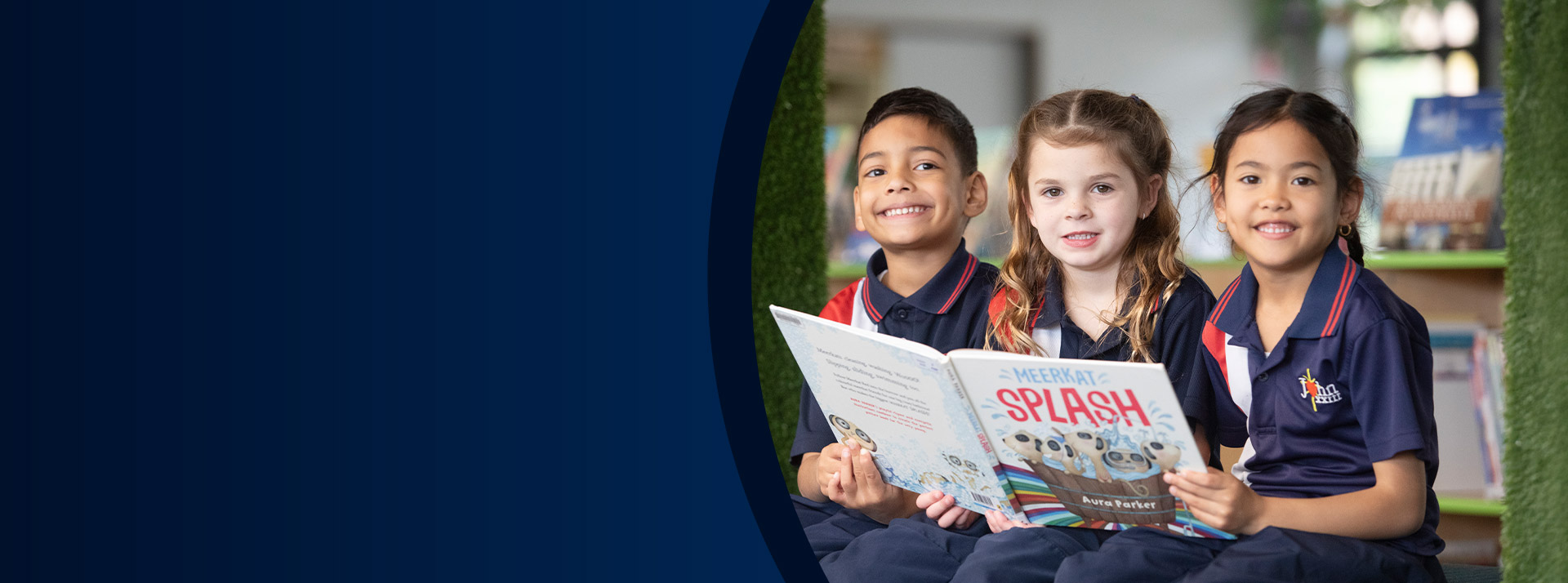 Students reading a book together in the library at St John XXIII College Stanhope Gardens