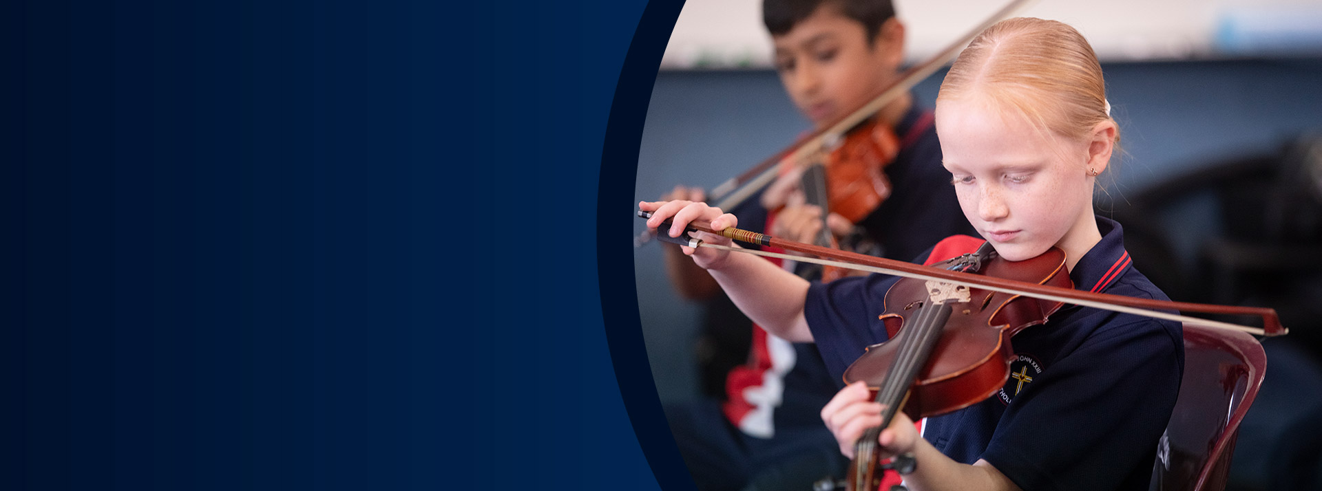 Students playing the violin in the classroom at St John XXIII College Stanhope Gardens