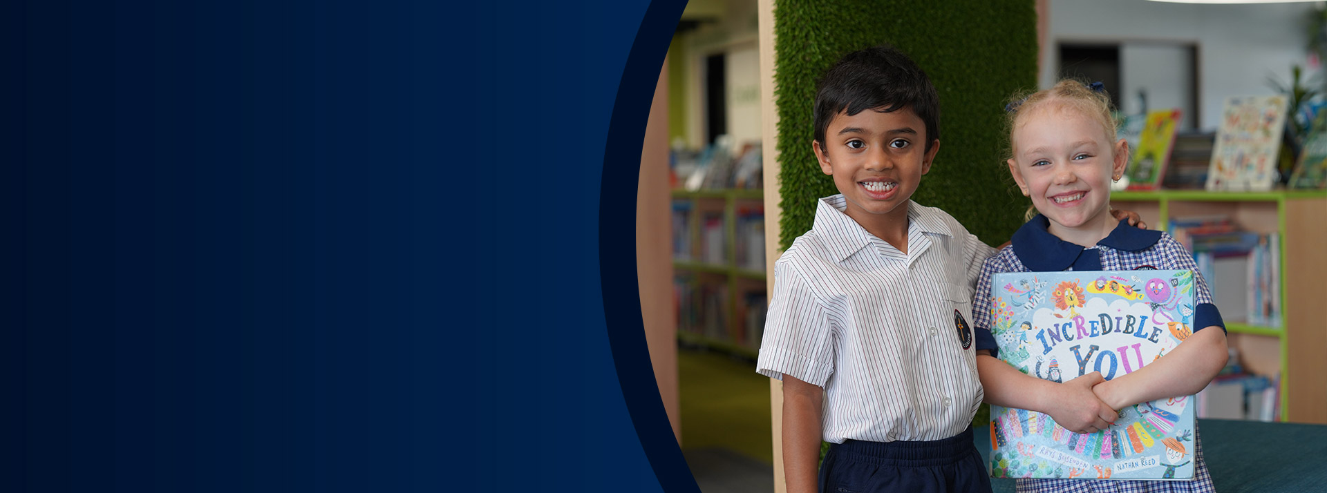 Students holding a book together in the library at St John XXIII College Stanhope Gardens