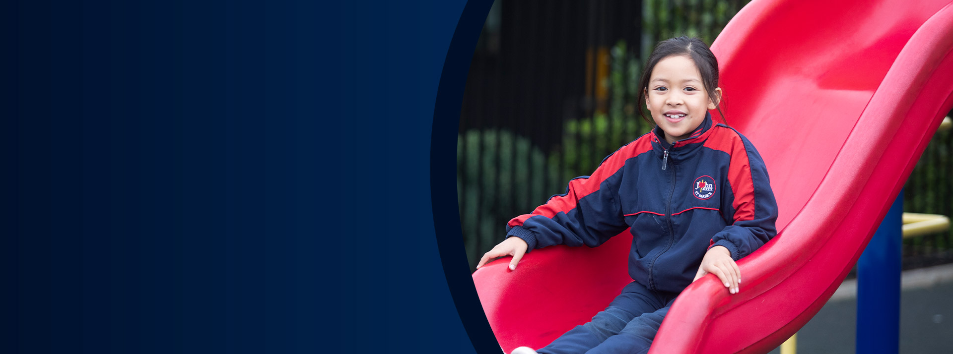 Student sliding down the slide in the playground at St John XXIII College Stanhope Gardens