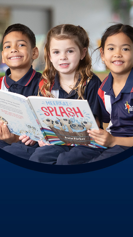 Students reading a book together in the library at St John XXIII College Stanhope Gardens