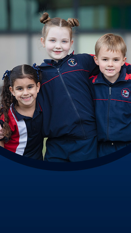 Students with their arms around each other in the school playground at St John XXIII College Stanhope Gardens