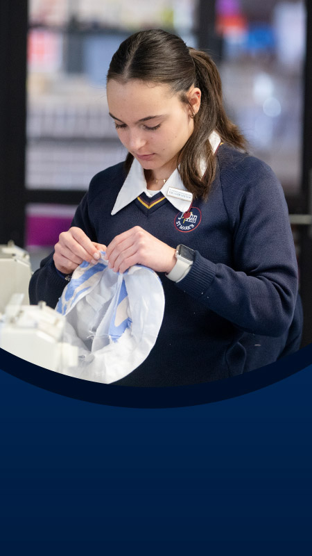 Student sewing in the classroom at St John XXIII College Stanhope Gardens