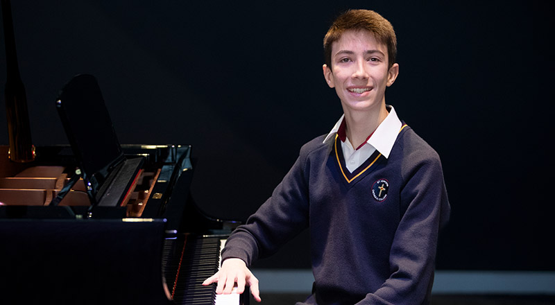 Student sitting in front of a piano at St John XXIII College Stanhope Gardens