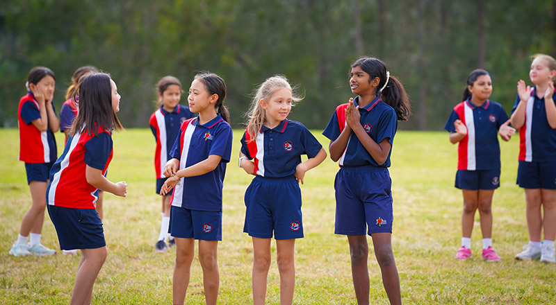 Students standing together on the oval at St John XXIII College Stanhope Gardens