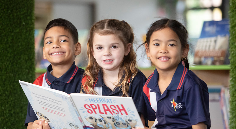 Students reading a book together in the library at St John XXIII College Stanhope Gardens