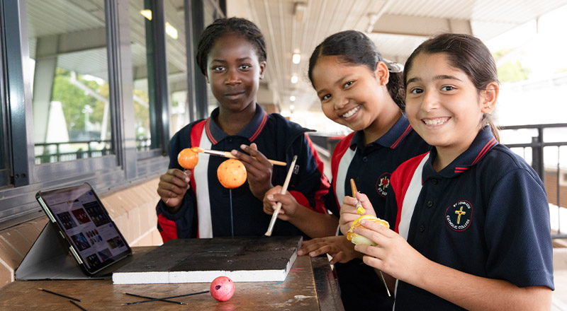 Students painting planets at St John XXIII College Stanhope Gardens