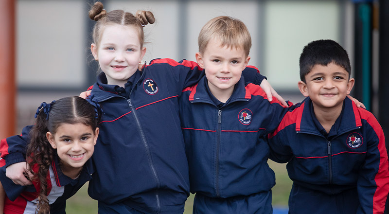 Students with their arms around each other in the playground at St John XXIII College Stanhope Gardens