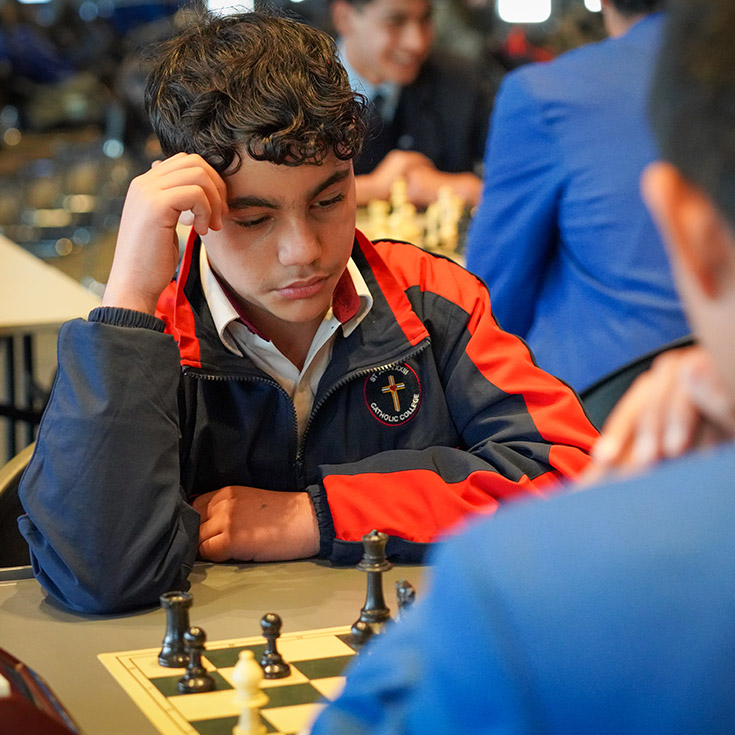 Student playing chess with his classmate at St John XXIII College Stanhope Gardens
