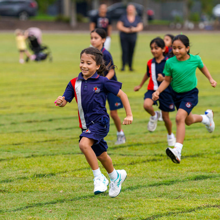 Students in a running race at the athletics carnival at St John XXIII College Stanhope Gardens