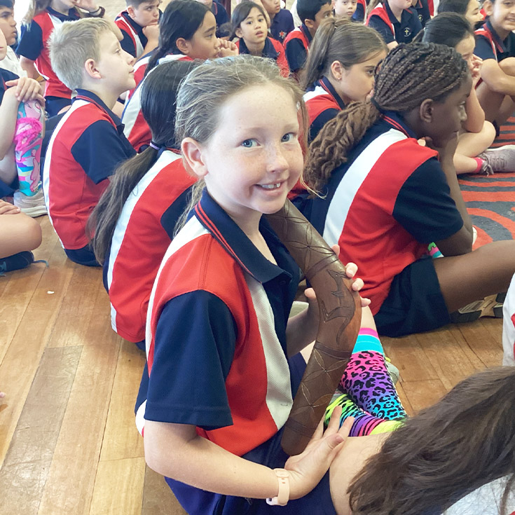 Student holding a boomerang at St John XXIII College Stanhope Gardens